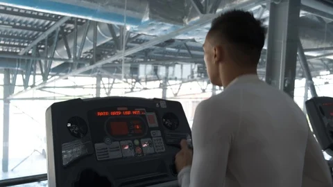 Young Asian guy is running on a treadmill in a gym. Stock Footage 114291388