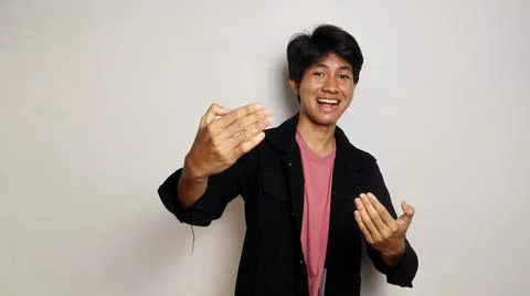 Young Asian handsome man over isolated white background inviting to come wi.. 스톡 사진