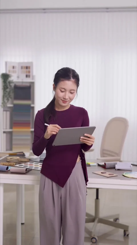 Young Asian interior designer architect reviewing furniture design plan usi.. Stock Footage 336560700