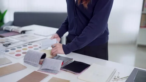 Young Asian interior designer selecting fabric swatches and color samples a.. Stock Footage 345149034