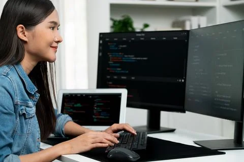 Young Asian in IT creating with typing online information on pc. Stratagem. Stock-Fotos