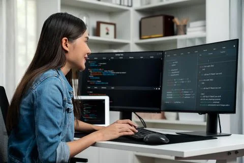 Young Asian in IT creating with typing online information on pc. Stratagem. Stock-Fotos
