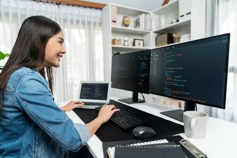 Young Asian in IT creating with typing online information on pc. Stratagem. Stock-Fotos