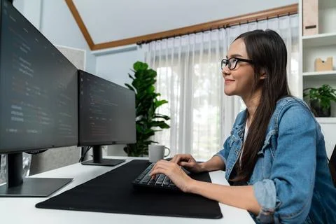 Young Asian in IT creating with typing online information on pc. Stratagem. 스톡 사진
