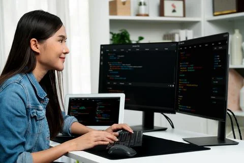 Young Asian in IT creating with typing online information on pc. Stratagem. Stock-Fotos