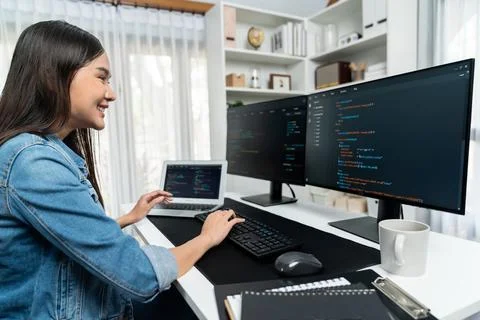 Young Asian in IT creating with typing online information on pc. Stratagem. Stock-Fotos