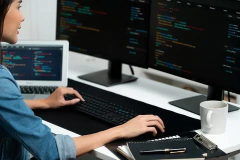 Young Asian in IT creating with typing online information on pc. Stratagem. Foto stock