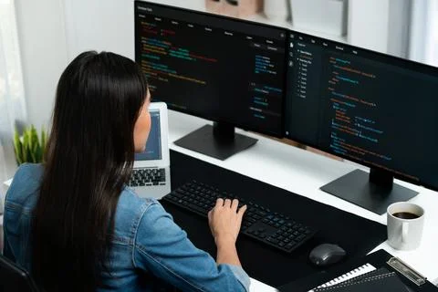 Young Asian in IT creating with typing online information on pc. Stratagem. Stock-Fotos