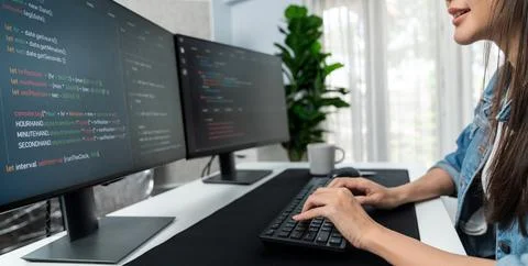 Young Asian in IT creating with typing online information on pc. Stratagem. Stock-Fotos