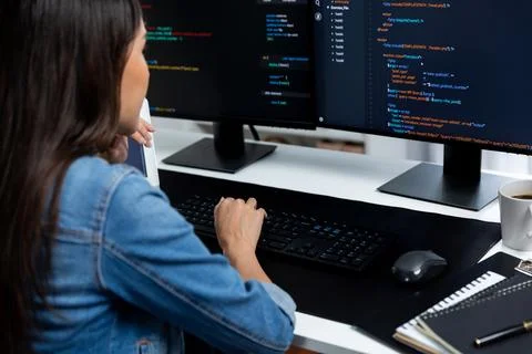 Young Asian in IT creating with typing online information on pc. Stratagem. Foto stock