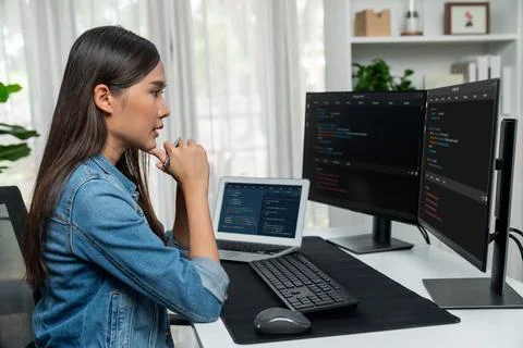 Young Asian in IT developer looking online information on pc to pose. Stratagem. Stockfoto's