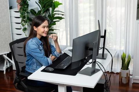 Young Asian in IT developer looking online information on pc to pose. Stratagem. Stock Photos