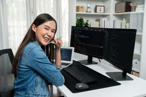 Young Asian in IT developer looking at camera to present on pc. Stratagem. 스톡 사진