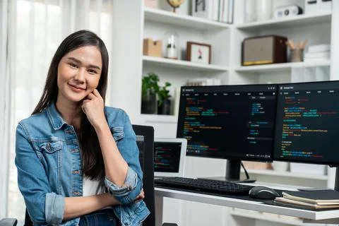 Young Asian in IT developer looking at camera to present on pc. Stratagem. 스톡 사진