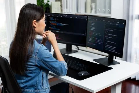 Young Asian in IT developer looking online information on pc to pose. Stratagem. Stockfoto's