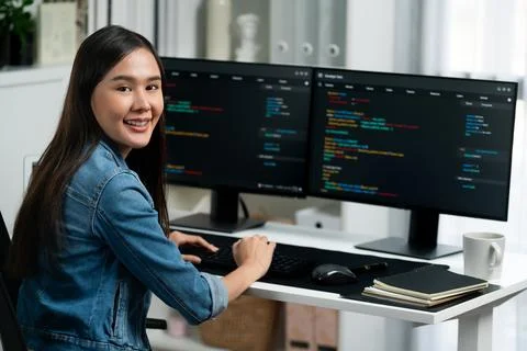 Young Asian in IT developer looking at camera to present on pc. Stratagem. 스톡 사진