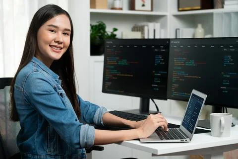 Young Asian in IT developer looking at camera to present on pc. Stratagem. 스톡 사진