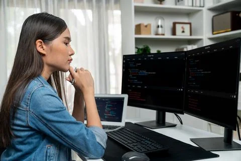 Young Asian in IT developer looking online information on pc to pose. Stratagem. Foto stock