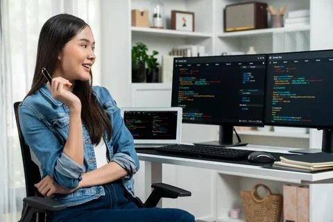 Young Asian in IT developer looking online information on pc to pose. Stratagem. Foto stock