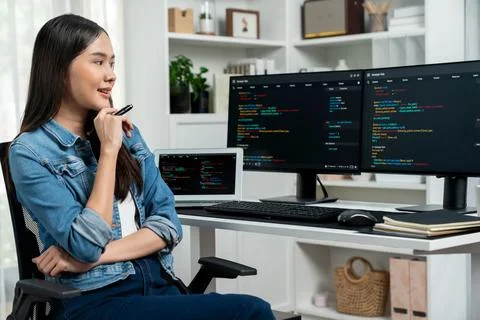 Young Asian in IT developer looking online information on pc to pose. Stratagem. 스톡 사진