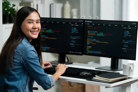 Young Asian in IT developer looking at camera to present on pc. Stratagem. Foto stock