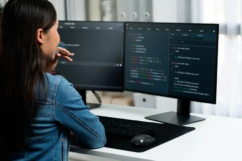 Young Asian in IT developer looking online information on pc to pose. Stratagem. 库存照片