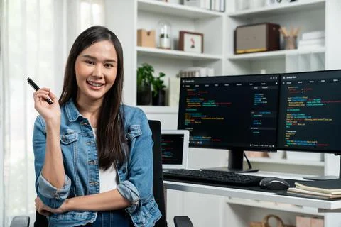 Young Asian in IT developer looking at camera to present on pc. Stratagem. 스톡 사진