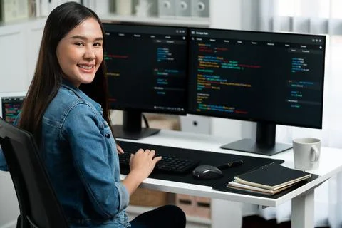 Young Asian in IT developer looking at camera to present on pc. Stratagem. Stock Photos