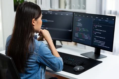 Young Asian in IT developer looking online information on pc to pose. Stratagem. Stock Photos
