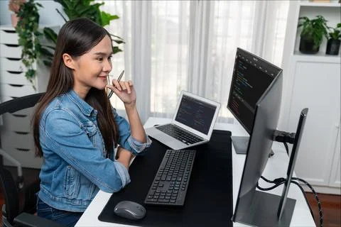 Young Asian in IT developer looking online information on pc to pose. Stratagem. Stock Photos