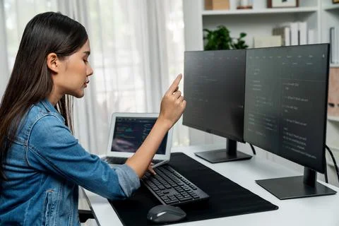 Young Asian in IT developer pointing online information on pc. Stratagem. Stock Photos
