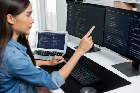 Young Asian in IT developer pointing online information on pc. Stratagem. Stock Photos