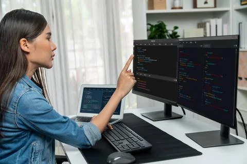 Young Asian in IT developer pointing online information on pc. Stratagem. Stockfoto's