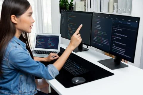 Young Asian in IT developer pointing online information on pc. Stratagem. Stock Photos
