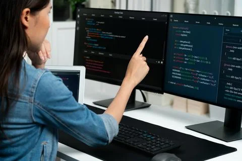 Young Asian in IT developer pointing online information on pc. Stratagem. Stock Photos