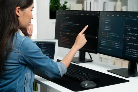 Young Asian in IT developer pointing online information on pc. Stratagem. 스톡 사진