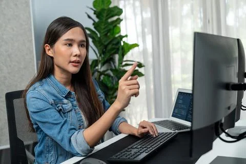 Young Asian in IT developer pointing online information on pc. Stratagem. 스톡 사진
