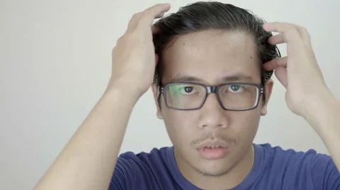 Young Asian Man Arranges His Hair Using Hand in front of Camera Slow Motion Stock Footage 59948539