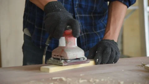 Young Asian man carpenter worker use grinder machine Stock Footage 124884027