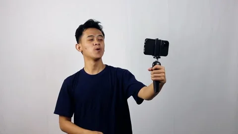 Young asian man is creating social media content Stock Footage 314935685