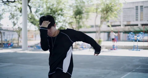 Young Asian man is dancing freestyle under a dome in the park. Stock-Footage 313121477