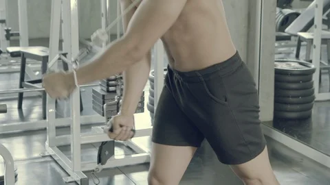 Young asian man doing cable rope triceps pull up exercise for bodybuilding in Stock Footage 121461483