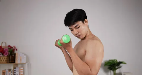 Young asian man doing dumbbells exercises at home. Athletic sport man practicing 스톡 동영상 201580298