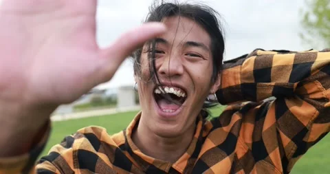 Young asian man doing high five in front of camera Stock Footage 192384335