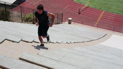 Young Asian Man Exercising Running up Stadium Steps Stock Footage 15876230