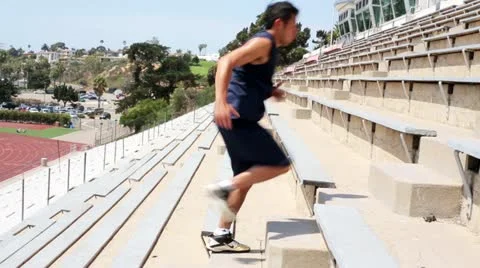 Young Asian Man Exercising Running up Stadium Steps Side View Stock Footage 16502693