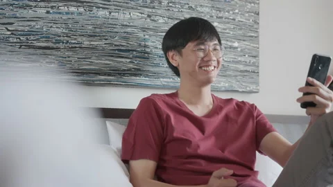 Young Asian Man Freelancer talking on cellphone by facetime application. Video stock 213581125
