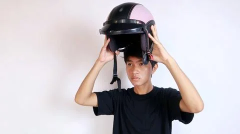 Young Asian man gesturing using a helmet 写真素材