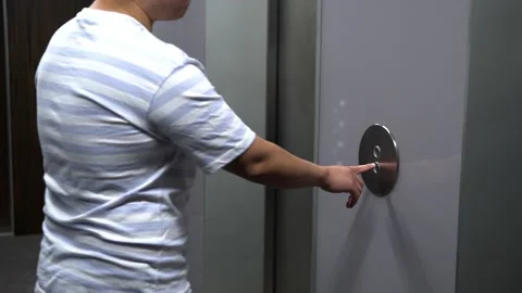 A young Asian man gets into an elevator and pushes a button Video stock 168418888