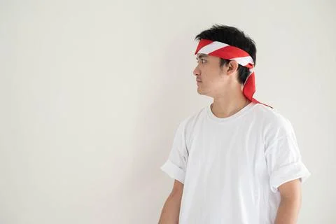 A young Asian man is looking at the left side in Hari Kemerdekaan Indonesia.. Stock Photos